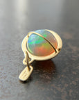 Ethiopian opal orb pendant set in 18k gold