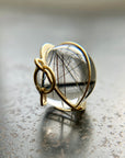 black tourmaline in quartz orb captured in 18k gold pendant