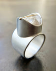 Silver ring with a enhydro quartz stone set with a gold crossbar