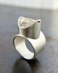 Silver ring with a enhydro quartz stone set with a gold crossbar