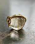 golden rutilated quartz orb pendant captured in 18k gold
