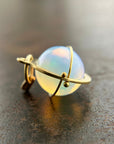 An ethiopian opal orb pendant in an 18k gold setting