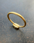 gold ring on a dark grey surface