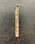 Necklace with a colorful sapphire beaded pendant on a dark surface