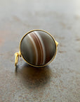 saturn agate orb with bands of color set in 18k gold