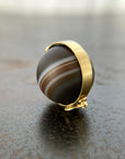 saturn agate orb with bands of color set in 18k gold