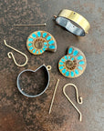 process photo of ammonite with embedded turquoise earrings in silver and gold on gold hooks