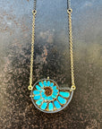 ammonite with embedded turquoise necklace in silver and gold on silver and gold chain
