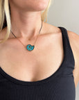 model wearing ammonite with embedded turquoise necklace in silver and gold on silver and gold chain