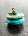 chinese hand carved turquoise beads with an 18k gold bale.