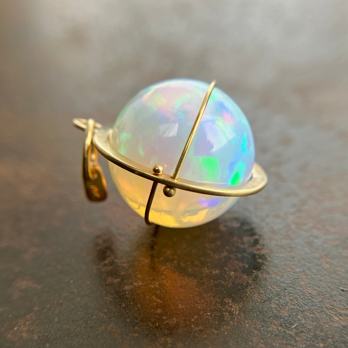 Ethiopian opal orb pendant set in 18k gold  