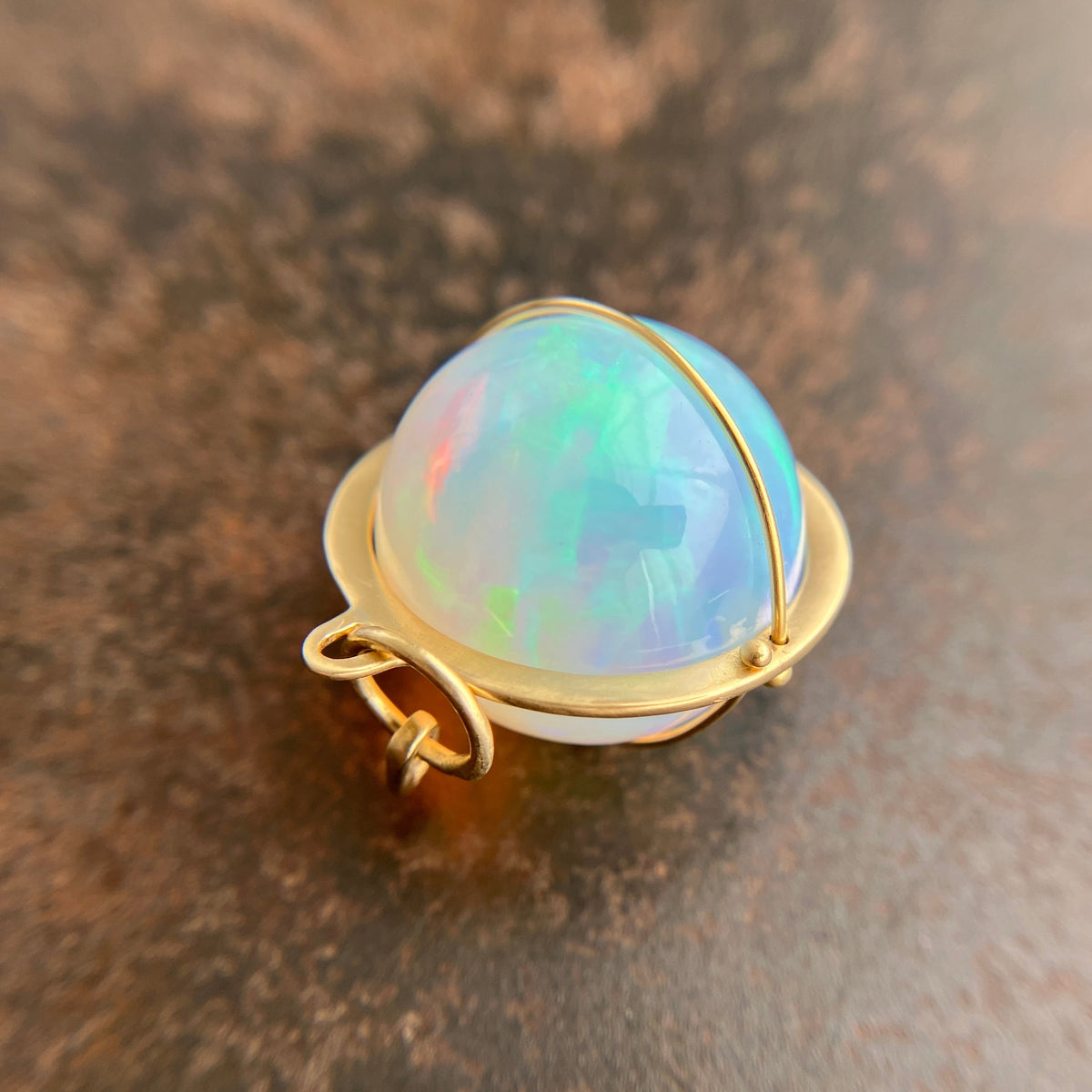 Ethiopian opal orb pendant set in 18k gold  