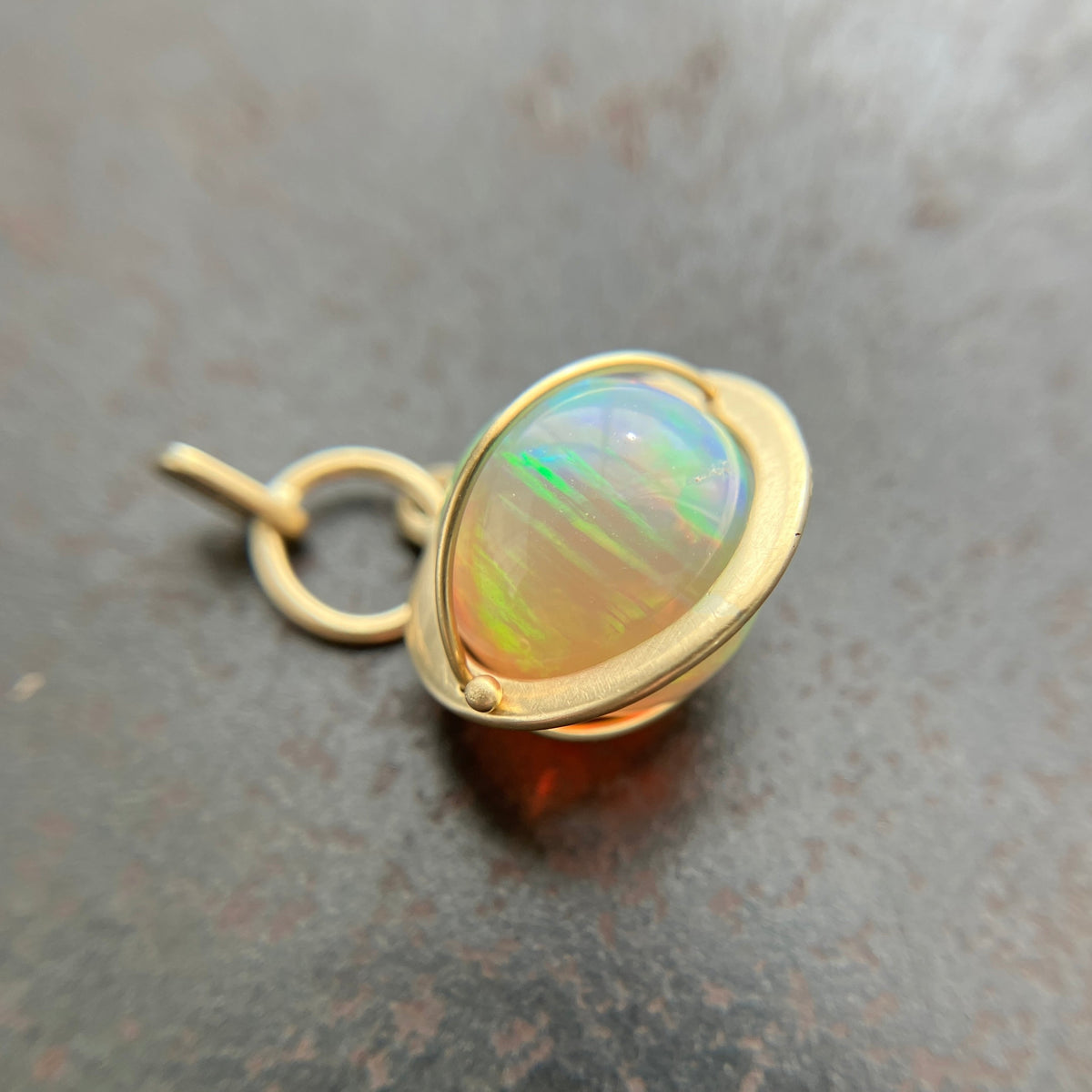 Ethiopian opal orb pendant set in 18k gold  