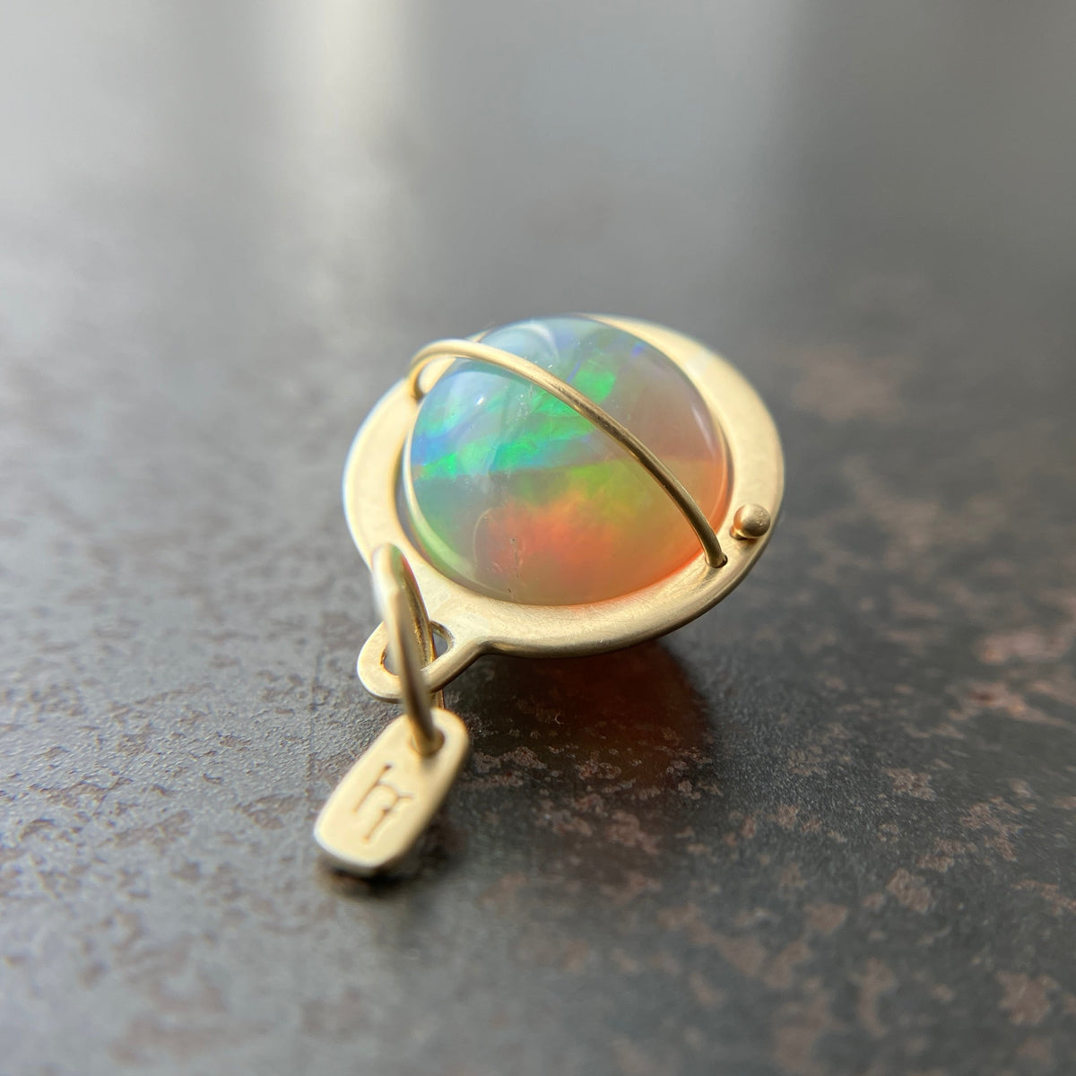 Ethiopian opal orb pendant set in 18k gold  