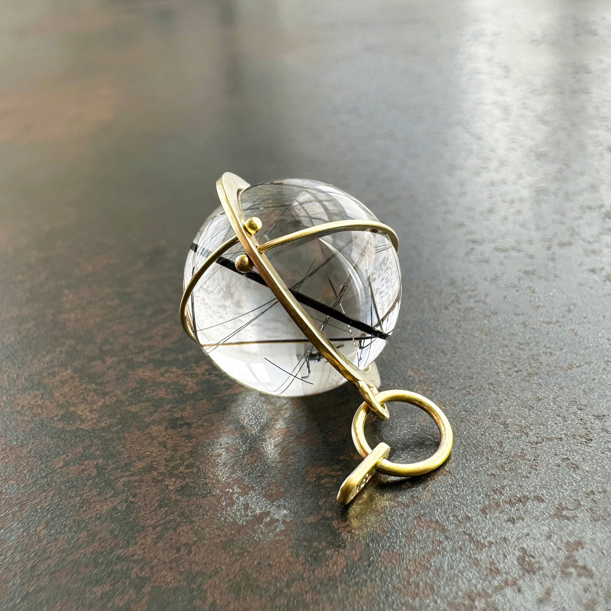 black tourmaline in quartz orb set in 18k gold pendant