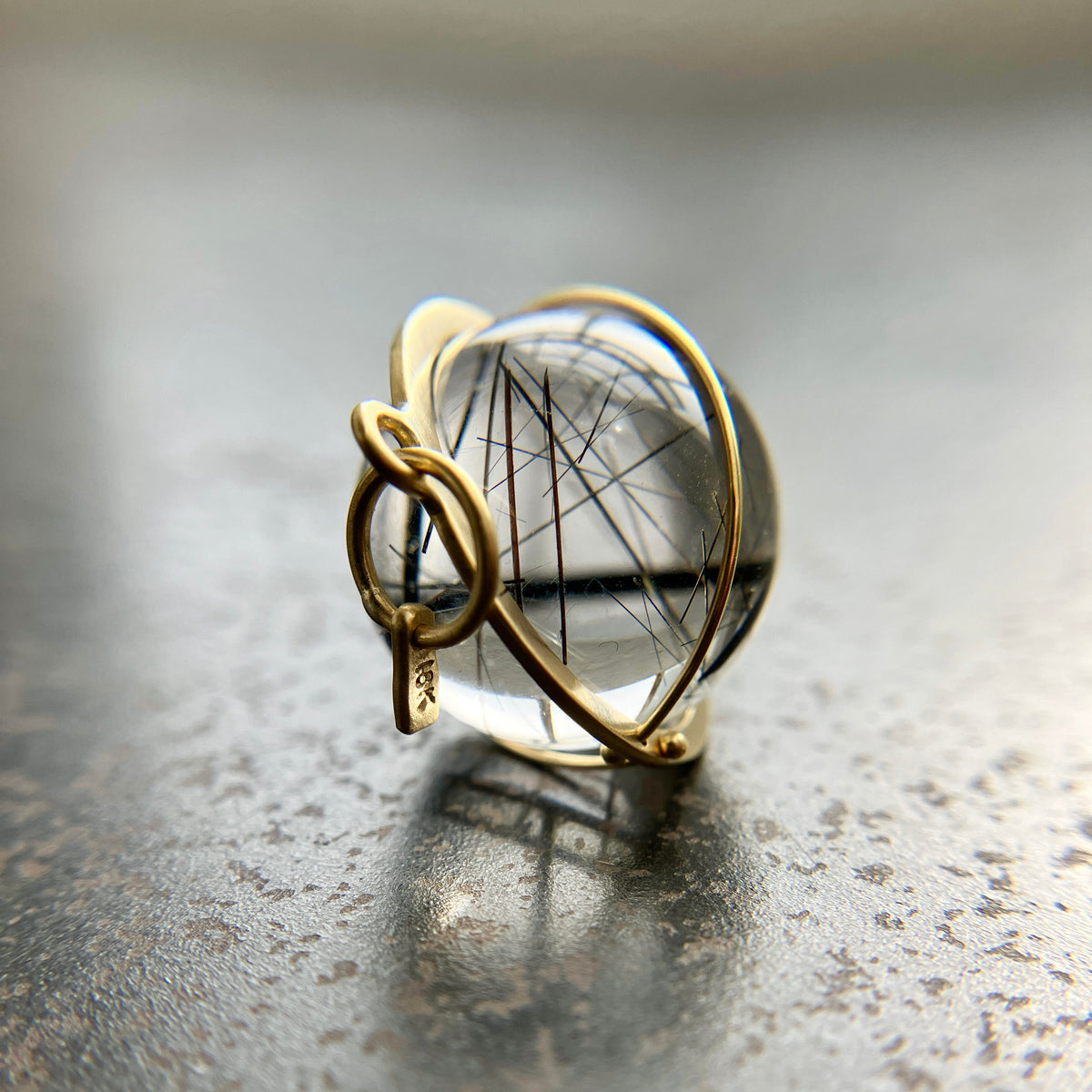 black tourmaline in quartz orb captured in 18k gold pendant