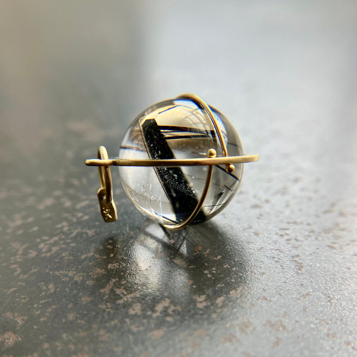 black tourmaline in quartz orb captured in 18k gold pendant
