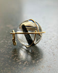black tourmaline in quartz orb captured in 18k gold pendant