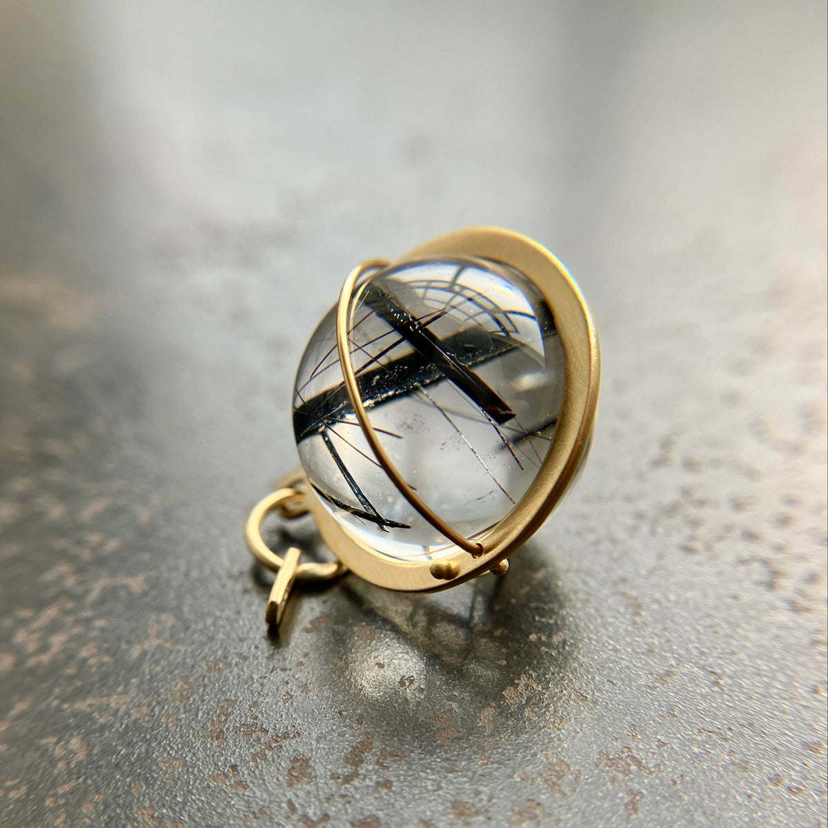 black tourmaline in quartz orb captured in 18k gold pendant