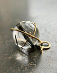 black tourmaline in quartz orb captured in 18k gold pendant