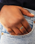 Hand with a blue diamond gold ring in a pocket of blue jeans