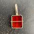 14k gold carnelian pendant on a gray surface