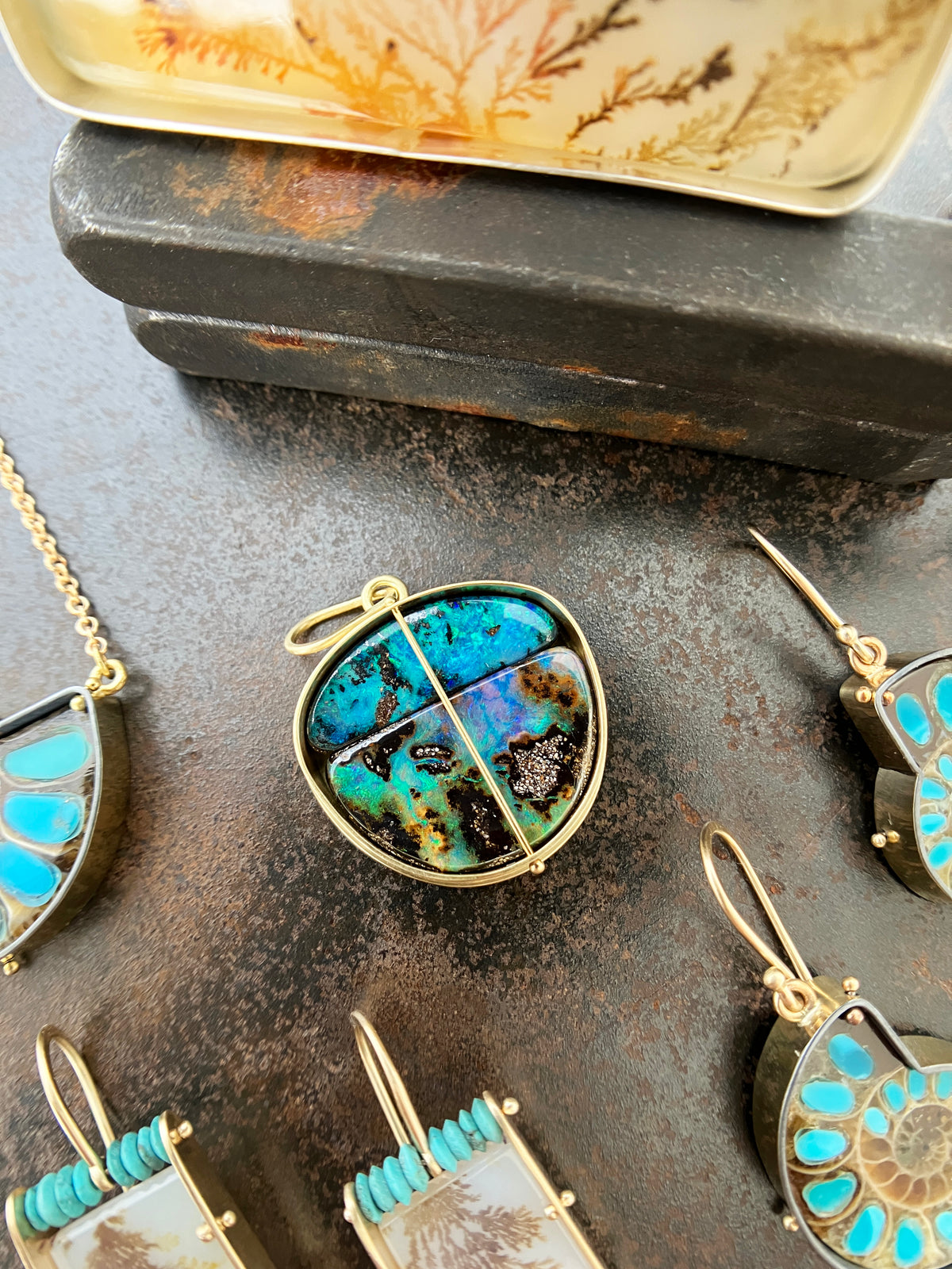 gold pendant with two boulder opals shown with collection of other pieces