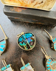 gold pendant with two boulder opals shown with collection of other pieces