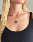 Model wearing gold pendant with two boulder opals
