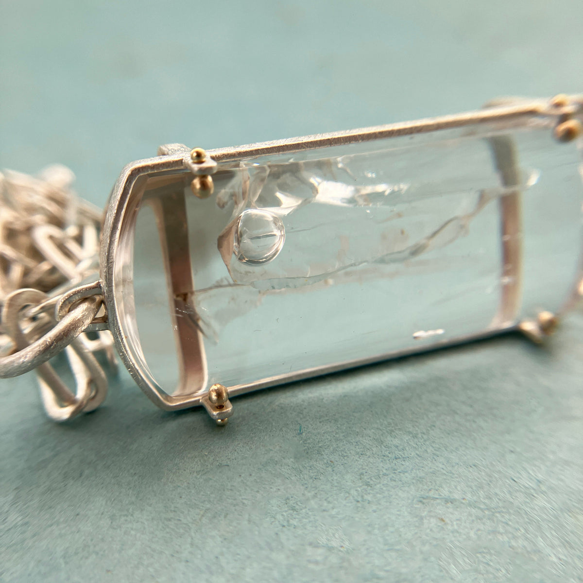 enhydro quartz pendant in silver and 18k gold
