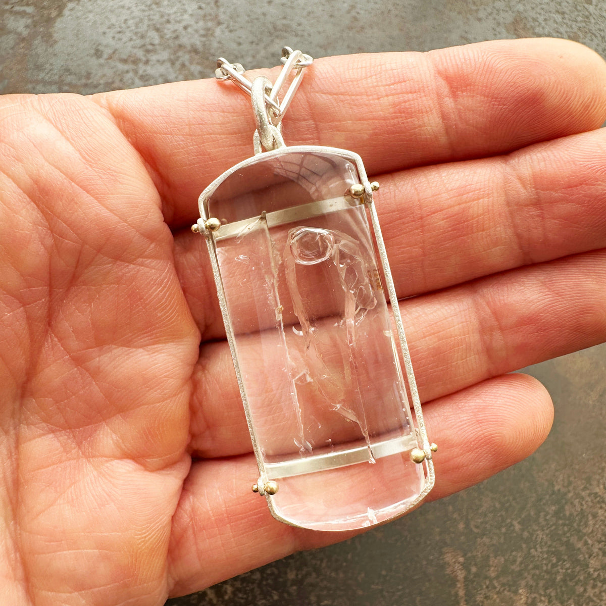 enhydro quartz pendant in silver and 18k gold