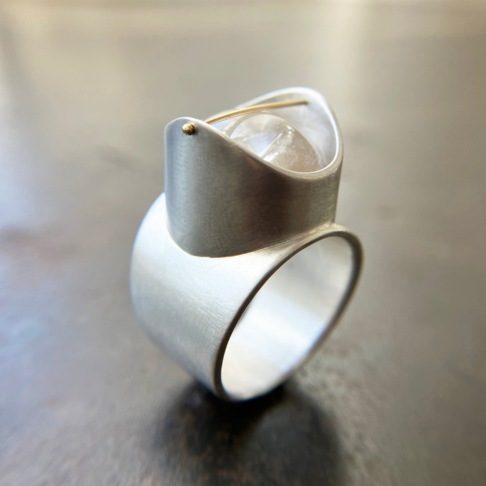 Silver ring with a enhydro quartz stone set with a gold crossbar