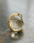 golden rutilated quartz orb pendant captured in 18k gold