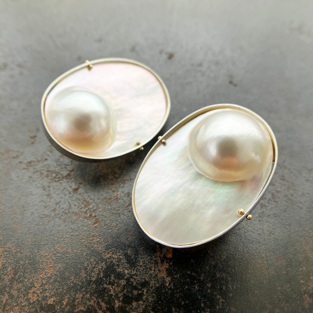 oval mabe pearl earrings set in sterling silver with 14k gold ball rivets