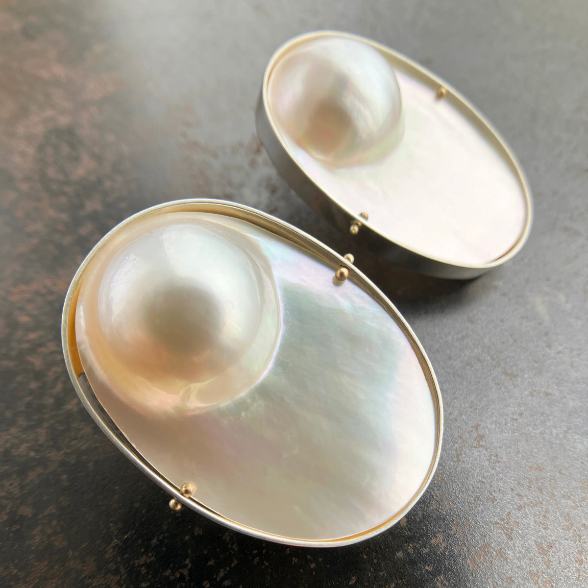 oval mabe pearl earrings set in sterling silver with 14k gold ball rivets