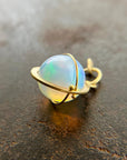 An ethiopian opal orb pendant in an 18k gold setting