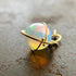 An ethiopian opal orb pendant in an 18k gold setting