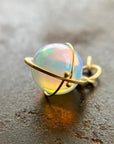 An ethiopian opal orb pendant in an 18k gold setting