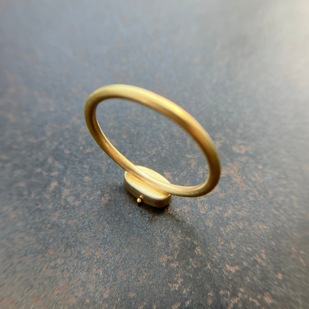 gold ring on a dark grey surface