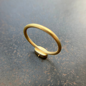 gold ring on a dark grey surface