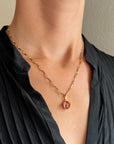 pink tourmaline oval pendant in 18k gold on a model