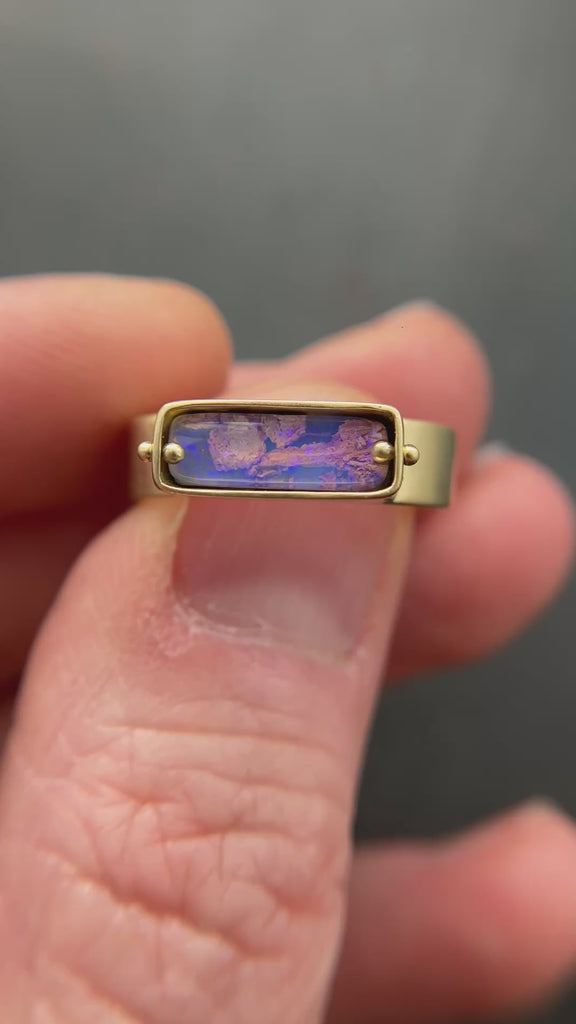 purple wood opal set in an 8k gold ring