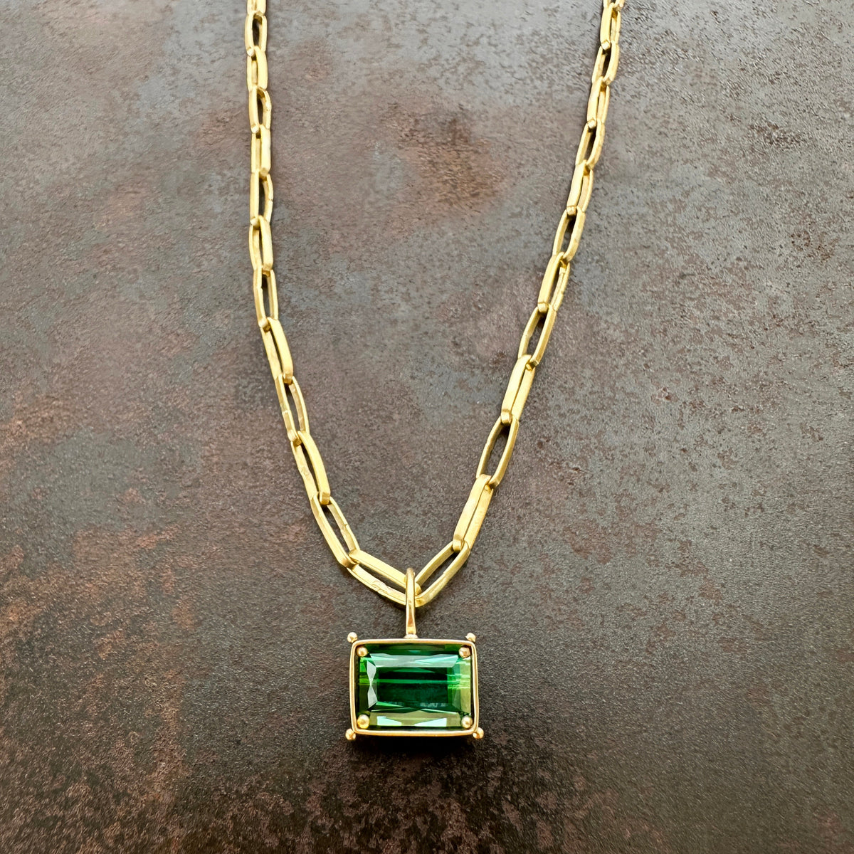 green radiant cut tourmaline pendant in 18k gold