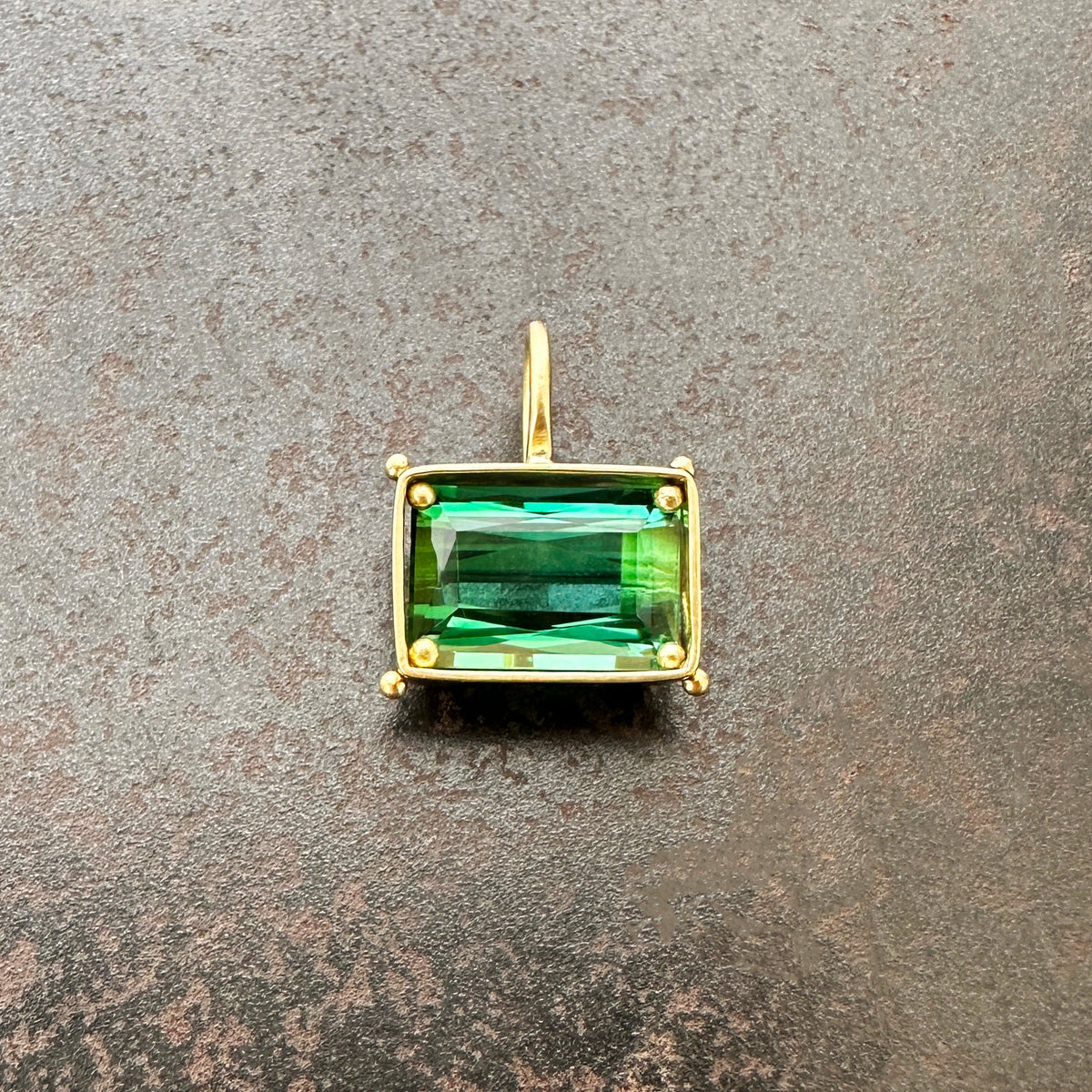 green radiant cut tourmaline pendant in 18k gold