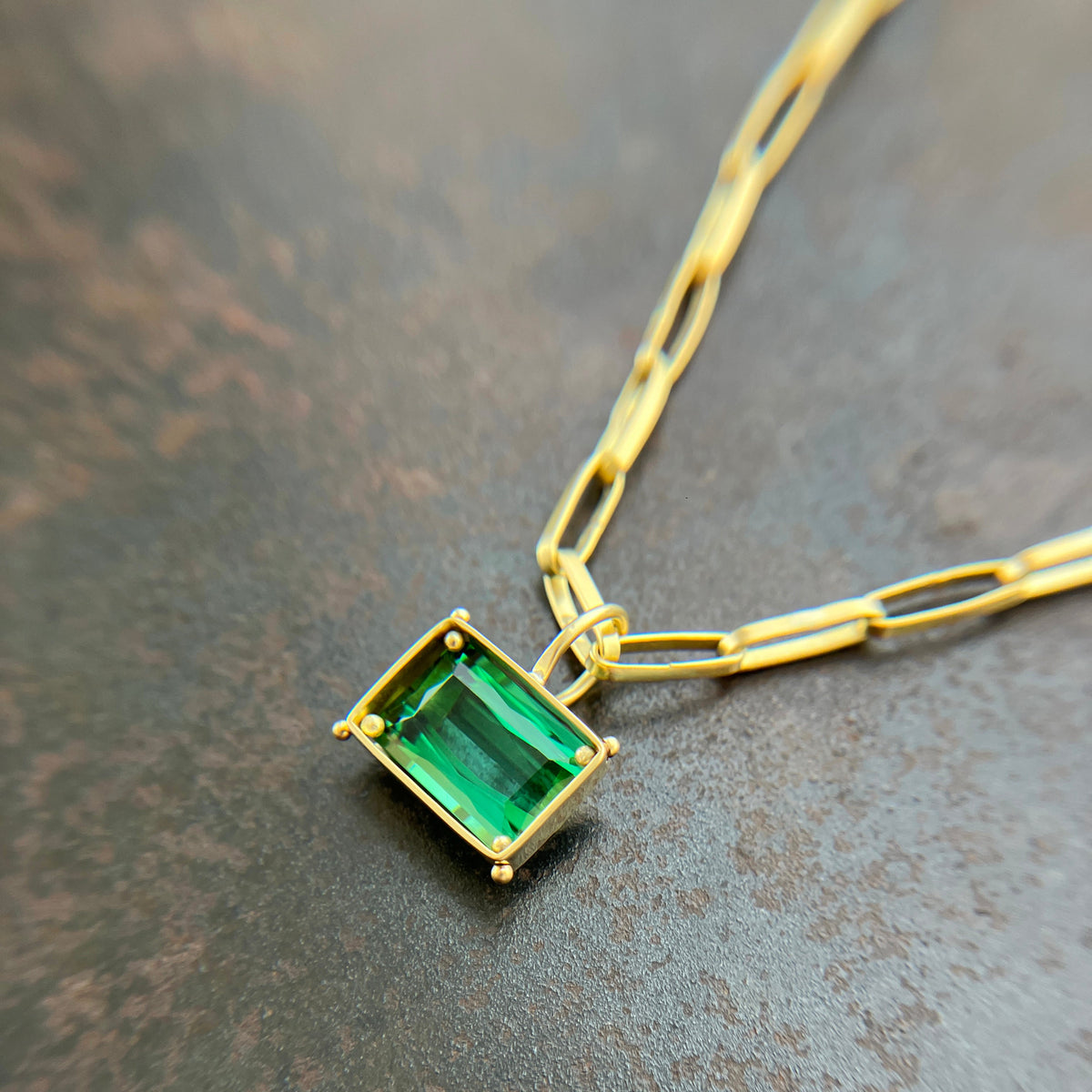 green radiant cut tourmaline pendant in 18k gold