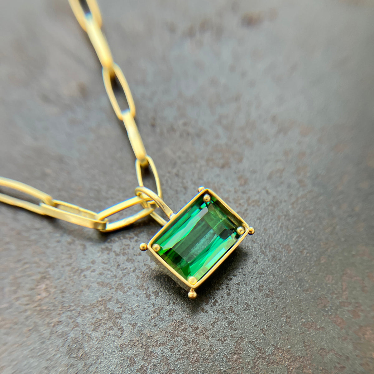 green radiant cut tourmaline pendant in 18k gold