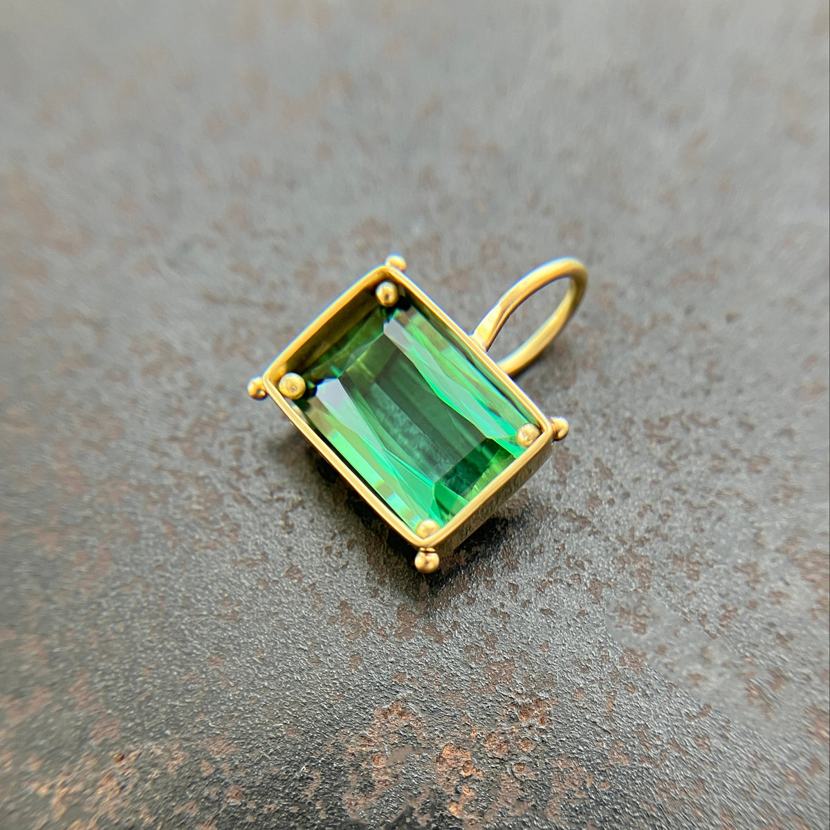 green radiant cut tourmaline pendant in 18k gold