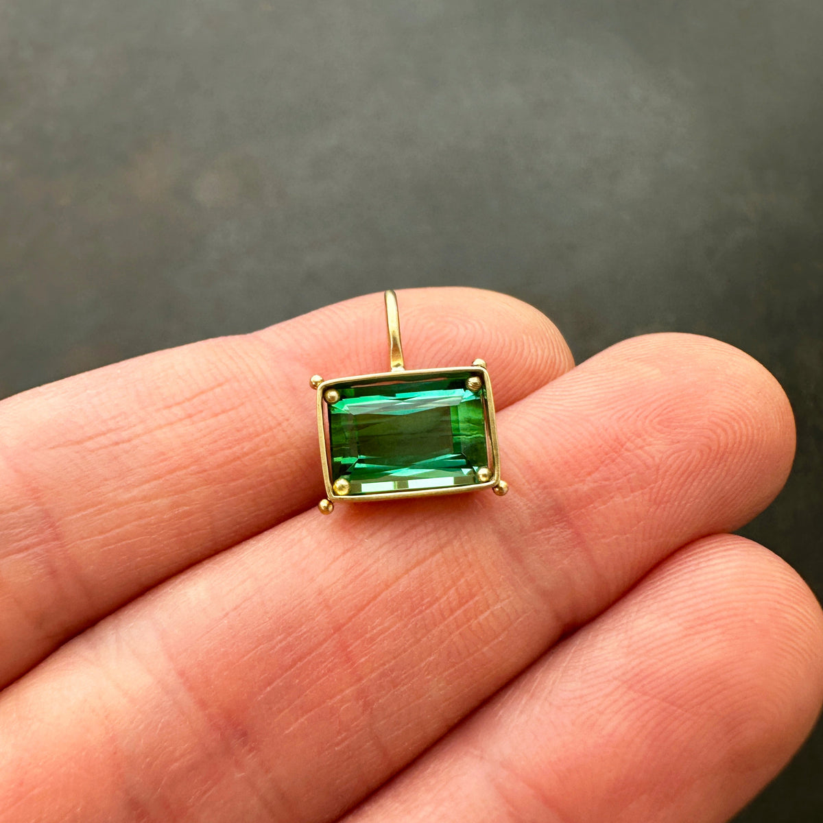 green radiant cut tourmaline pendant in 18k gold