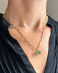 green radiant cut tourmaline pendant in 18k gold on a model
