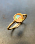 Gold ring with a opal gemstone on a metallic surface